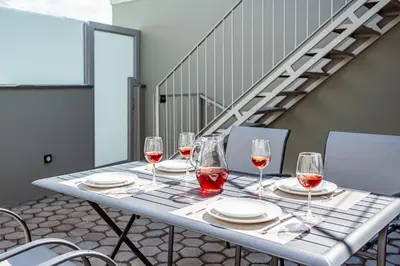 four wine glasses sitting on a table on a balcony at Cocoon House in Canhas