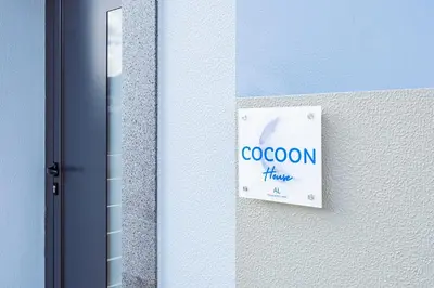 a sign on the side of a building at Cocoon House in Canhas