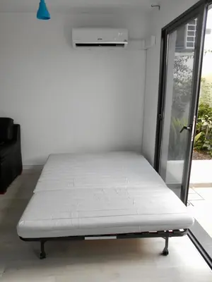a white bed in a room with a window at Holiday Apartments Funchal - Bouganvilla in Funchal
