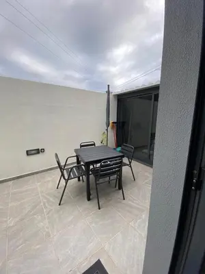 a table and chairs sitting on a patio at Holiday Apartments Funchal - Bouganvilla in Funchal