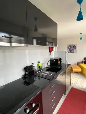 a kitchen with a black counter top in a room at Holiday Apartments Funchal - Bouganvilla in Funchal