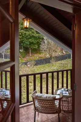 a view of a porch with a table and chairs at A refuge in nature - Chalet D'Avó Teresa in São Vicente