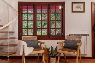 a room with two chairs and a window at A refuge in nature - Chalet D'Avó Teresa in São Vicente