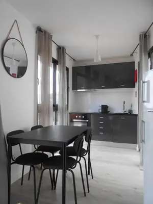 a black dining room table and chairs in a kitchen at Holiday apartments Funchal - Rosemary in Funchal