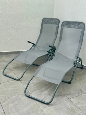 two empty chairs sitting on a tile floor at Holiday apartments Funchal - Rosemary in Funchal