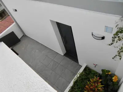 an overhead view of a hallway with a door and plants at Holiday apartments Funchal - Rosemary in Funchal