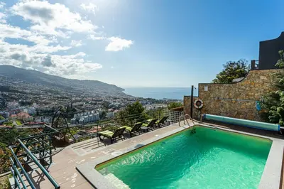 a swimming pool on top of a building at Casa Barcelos View in Funchal