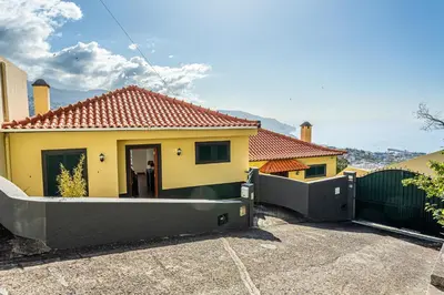 a yellow house with a gate and a fence at Casa Barcelos View in Funchal