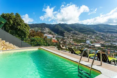 a swimming pool with a view of a city at Casa Barcelos View in Funchal