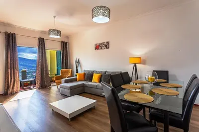 a living room with a couch and a table at Casa Barcelos View in Funchal