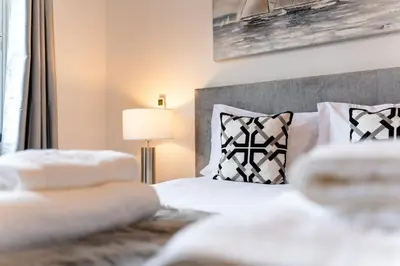 a bedroom with a bed with white sheets and pillows at GuestReady - Scenic Retreat with Stunning Views in São Vicente