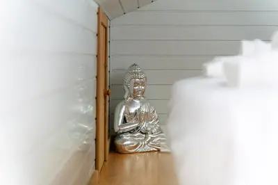 a silver buddha statue sitting in a hallway at GuestReady - Scenic Retreat with Stunning Views in São Vicente