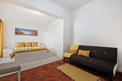 a white bedroom with a bed and a couch at Quinta Paraiso in Funchal