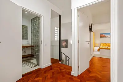 a hallway with a door leading into a living room with a mirror at Quinta Paraiso in Funchal