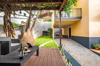a patio with a table with wine bottles on it at Quinta Paraiso in Funchal