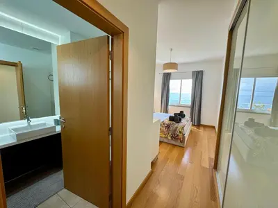 a bathroom with a door leading to a bedroom with a sink at Welcome to Paradise Island in Caniço