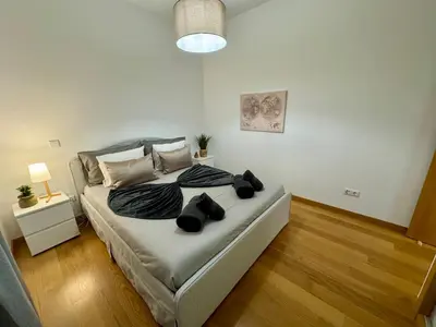 a bedroom with a bed with two black dogs on it at Welcome to Paradise Island in Caniço