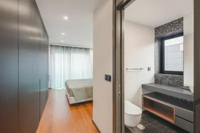 a bathroom with a toilet and a bedroom at Best View Funchal Vacation Apartment in Funchal