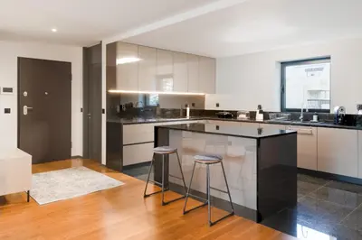 a kitchen with a large island with two bar stools at Best View Funchal Vacation Apartment in Funchal