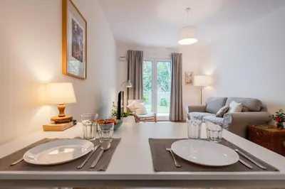 a living room with a table with two plates on it at Alamos Charming Apartments - Garden in Funchal