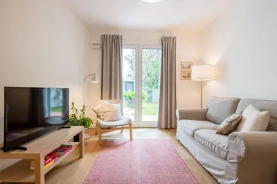 a living room with a couch and a flat screen tv at Alamos Charming Apartments - Garden in Funchal