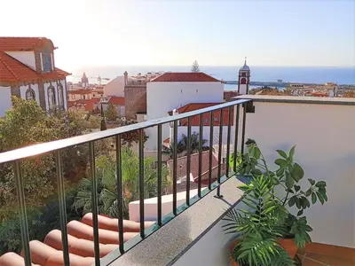 a balcony with a view of a city and the ocean at Alamos Charming Apartments - Family in Funchal
