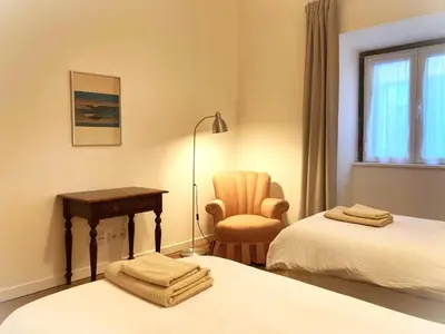 a room with two beds and a desk and a chair at Alamos Charming Apartments - Family in Funchal