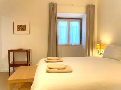 a bedroom with a bed with two towels on it at Alamos Charming Apartments - Family in Funchal