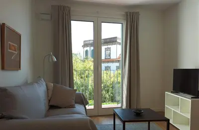 an apartment building with a balcony with chairs and tables at Alamos Charming Apartment - View in Funchal