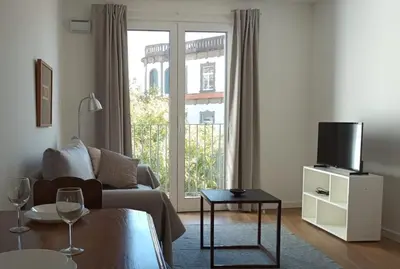 a living room with a couch and a tv at Alamos Charming Apartment - View in Funchal