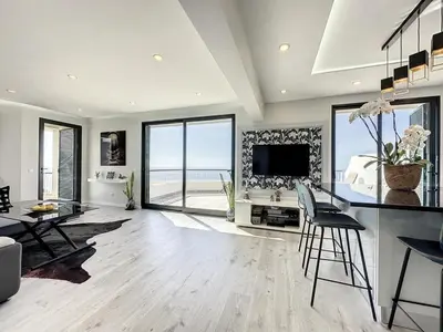 a large living room with a table and chairs at Endless Holiday 2 Bedroom Apartment Lido in Funchal