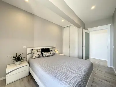 a bedroom with a large bed and a window at Endless Holiday 2 Bedroom Apartment Lido in Funchal
