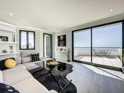 a living room with a couch and a large window at Endless Holiday 2 Bedroom Apartment Lido in Funchal