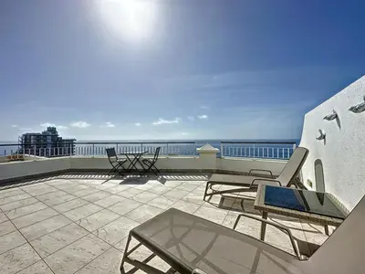 a patio with chairs and a view of the ocean at Endless Holiday 2 Bedroom Apartment Lido in Funchal