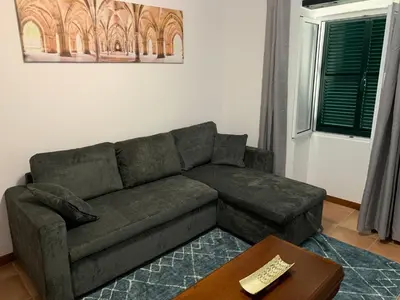 a living room with a couch and a table at Amélia's House in Seixal