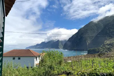 a house with a view of the ocean and mountains at Amélia's House in Seixal