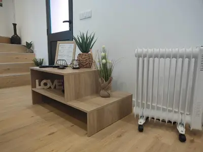 a room with a radiator and a table with plants at Casa da Cristina in Santa Cruz