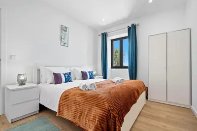 a bedroom with a bed with two towels on it at Casa da Cristina in Santa Cruz