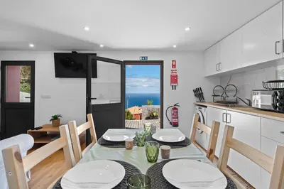 a kitchen and dining room with a table and chairs at Casa da Cristina in Santa Cruz