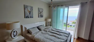 a bedroom with a bed and a large window at VillaMadeira - Apartments in Funchal in Funchal