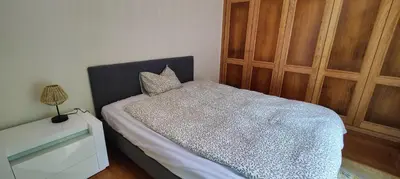 a bedroom with a bed and a wooden cabinet at VillaMadeira - Apartments in Funchal in Funchal