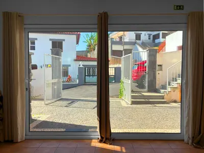 a sliding glass door with a view of a courtyard at VillaMadeira - Apartments in Funchal in Funchal