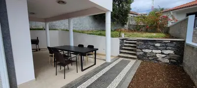 a black table and chairs on a patio at VillaMadeira - Apartments in Funchal in Funchal