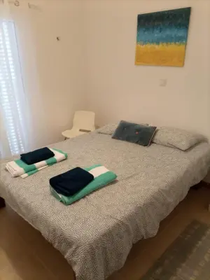 a bed with two pillows on top of it at Vivenda Nina in Porto Santo
