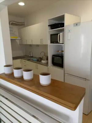 a kitchen with a wooden counter with three bowls on it at Vivenda Nina in Porto Santo