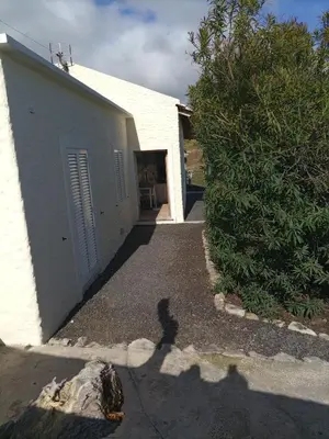 a shadow of a person standing in front of a building at Vivenda Nina in Porto Santo