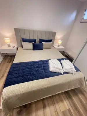 a bedroom with a large bed with blue sheets and blue pillows at Filipe's Green Landscape in Tábua