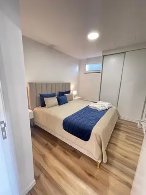 a bedroom with a large bed with blue pillows at Filipe's Green Landscape in Tábua