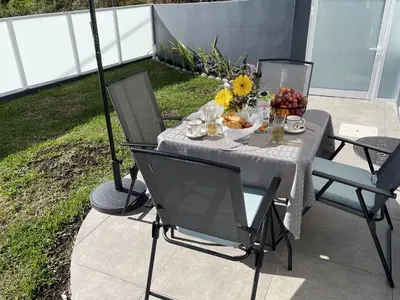 a table with a bowl of fruit and flowers on it at Filipe's Green Landscape in Tábua