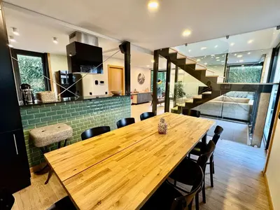a living room with two chairs and a table at Square house in Funchal